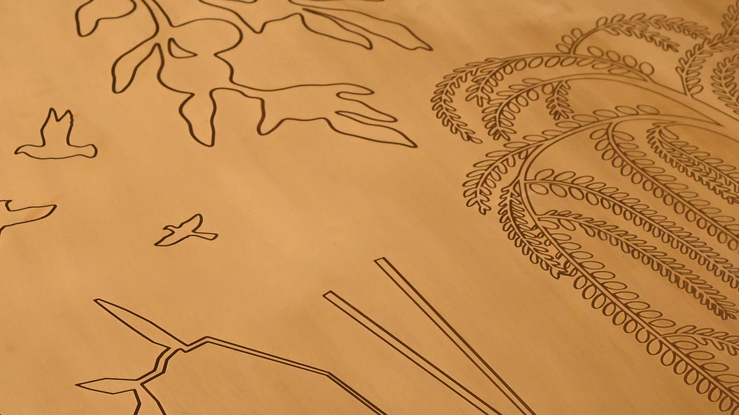 Engraved brass surface of the Sun’s Grace table
