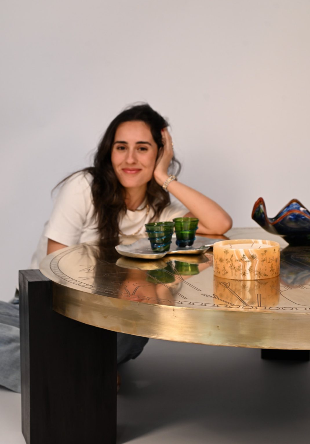 Alia Zaghloul seated at the Sun’s Grace coffee table